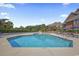 Inviting outdoor pool surrounded by lounge chairs and umbrella tables at 410 Melrose Pl. # 308, Myrtle Beach, SC 29572