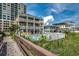 Beautiful exterior view showcasing a well-maintained beach house with a pool and lush landscaping at 4103 N Ocean Blvd. # 304, North Myrtle Beach, SC 29582