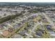 Expansive aerial shot of a residential area with a backdrop of trees and distant coastline at 419 Broadmoor Dr., Murrells Inlet, SC 29576