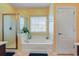 Bright bathroom with a shower and large tub with a window at 419 Broadmoor Dr., Murrells Inlet, SC 29576