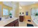 Bright bathroom with double sinks, large mirrors, and a bathtub shower at 419 Broadmoor Dr., Murrells Inlet, SC 29576