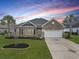 Charming brick home boasts manicured lawn, mature trees, and a convenient two-car garage in a beautiful community at 419 Broadmoor Dr., Murrells Inlet, SC 29576