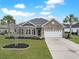 Charming brick home with a well-manicured lawn, mature trees, and a two-car garage at 419 Broadmoor Dr., Murrells Inlet, SC 29576