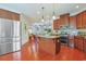 Expansive kitchen with stainless steel fridge, center island, granite countertops, and cherry cabinets, offering modern amenities at 419 Broadmoor Dr., Murrells Inlet, SC 29576