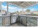 Outdoor kitchen featuring a high-end grill, stainless steel storage, and stone countertops, ideal for summer gatherings at 419 Broadmoor Dr., Murrells Inlet, SC 29576