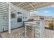 This outdoor kitchen boasts a built-in grill, stone accents, and ample counter space, perfect for entertaining at 419 Broadmoor Dr., Murrells Inlet, SC 29576