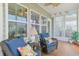 Inviting sunroom with wicker furniture, decorative pillows, and views of the outdoors at 419 Broadmoor Dr., Murrells Inlet, SC 29576