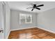 This bedroom features hardwood floors, ceiling fan, and large windows for natural light at 4320 Stevens St., Loris, SC 29569