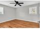 This bedroom features hardwood floors, ceiling fan, and two windows for natural light at 4320 Stevens St., Loris, SC 29569