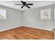 This bedroom features hardwood floors, ceiling fan, and two windows for natural light at 4320 Stevens St., Loris, SC 29569
