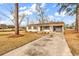 Charming one-story home featuring a brick exterior, mature trees, and a spacious front yard with a private driveway at 4320 Stevens St., Loris, SC 29569