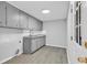 Kitchen features gray cabinets, laundry area, and natural light at 4320 Stevens St., Loris, SC 29569