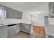 Updated kitchen features gray cabinets, stainless steel appliances, white subway tile backsplash, and durable floors at 4320 Stevens St., Loris, SC 29569