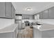Updated kitchen features gray cabinets, stainless steel appliances, white subway tile and wood-look tile floor at 4320 Stevens St., Loris, SC 29569