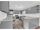 Updated kitchen features gray cabinets, stainless steel appliances, white subway tile and wood-look tile floor at 4320 Stevens St., Loris, SC 29569