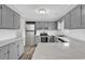 Updated kitchen features gray cabinets, stainless steel appliances, white subway tile and wood-look tile floor at 4320 Stevens St., Loris, SC 29569