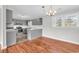 Eat-in kitchen features gray cabinets, stainless steel appliances, hardwood floors, and lots of natural light at 4320 Stevens St., Loris, SC 29569