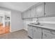 Kitchen features gray cabinets, stainless steel sink, and subway tile backsplash at 4320 Stevens St., Loris, SC 29569