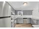 Updated kitchen features gray cabinets, stainless steel appliances, white subway tile backsplash, and durable floors at 4320 Stevens St., Loris, SC 29569