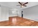 Spacious living room featuring hardwood floors, modern ceiling fan, and an open layout with neutral paint at 4320 Stevens St., Loris, SC 29569