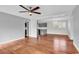 Spacious living area showcasing hardwood floors, a ceiling fan, and an open layout with easy access to the kitchen at 4320 Stevens St., Loris, SC 29569