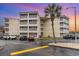 Three-story condo building featuring screened balconies and ample parking at 4350 Intercoastal Dr. # 1404, Little River, SC 29566