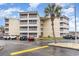 Three-story condo building featuring screened balconies and ample parking at 4350 Intercoastal Dr. # 1404, Little River, SC 29566