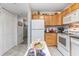 Well-lit kitchen with white appliances and a view of the hallway and pantry at 4350 Intercoastal Dr. # 1404, Little River, SC 29566