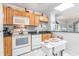 Kitchen features light wood cabinets, black countertops, and white appliances at 4350 Intercoastal Dr. # 1404, Little River, SC 29566