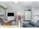 Bright living room features a television, dining table, and a glimpse of the balcony at 4350 Intercoastal Dr. # 1404, Little River, SC 29566