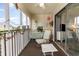 Charming screened patio featuring comfortable seating, a ceiling fan, and outdoor views at 4350 Intercoastal Dr. # 1404, Little River, SC 29566