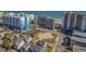 Aerial view of multiple condo buildings near a beach showing parking, pool, and access to the beach at 4719 S Ocean Blvd. # 209, North Myrtle Beach, SC 29582