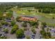 Aerial view of a golf course and clubhouse surrounded by lush greenery and a lake, showcasing the recreational facilities at 4719 S Ocean Blvd. # 209, North Myrtle Beach, SC 29582