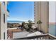 Balcony overlooking beach with partial ocean view, palm trees, and beach access at 4719 S Ocean Blvd. # 209, North Myrtle Beach, SC 29582