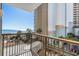 Balcony with ocean view, overlooking parking, palm trees, and beach access at 4719 S Ocean Blvd. # 209, North Myrtle Beach, SC 29582