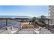 Ocean view from the balcony, equipped with white plastic chairs at 4719 S Ocean Blvd. # 209, North Myrtle Beach, SC 29582