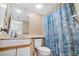 Cozy bathroom with a vanity, toilet, and shower featuring a seashell-themed curtain at 4719 S Ocean Blvd. # 209, North Myrtle Beach, SC 29582
