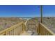 Scenic beach access with wooden stairs leading to the sandy shore and ocean views at 4719 S Ocean Blvd. # 209, North Myrtle Beach, SC 29582