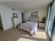 Comfortable bedroom with a queen bed, dresser, and ocean view, perfect for a tranquil retreat at 4719 S Ocean Blvd. # 209, North Myrtle Beach, SC 29582