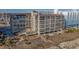 An exterior shot shows a multi-story condo building offering beachfront living with ample parking at 4719 S Ocean Blvd. # 209, North Myrtle Beach, SC 29582