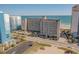 An exterior shot showcases a condo with parking, a pool, and beach access for convenient coastal living at 4719 S Ocean Blvd. # 209, North Myrtle Beach, SC 29582
