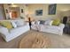 Cozy living room with white sofas, coastal decor, and a jute rug creating a relaxed and inviting atmosphere at 4719 S Ocean Blvd. # 209, North Myrtle Beach, SC 29582