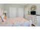 Light-filled bedroom with neutral walls, a white dresser, and three closets at 4803 Bovardia Pl. # 102, Myrtle Beach, SC 29577