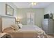 Comfortable bedroom with a full bed, dresser, and window with shutters at 4803 Bovardia Pl. # 102, Myrtle Beach, SC 29577