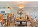 Open-concept dining room featuring stylish lighting, a wooden table, and seamless flow into the living area and kitchen at 4803 Bovardia Pl. # 102, Myrtle Beach, SC 29577