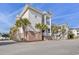 Multi-story condo building with lush landscaping and ample parking at 4803 Bovardia Pl. # 102, Myrtle Beach, SC 29577