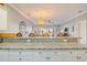Open kitchen layout with granite counters, white cabinets, and views of the living area and dining space at 4803 Bovardia Pl. # 102, Myrtle Beach, SC 29577