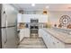Bright kitchen featuring granite countertops, stainless steel appliances, white cabinets, and a convenient breakfast bar at 4803 Bovardia Pl. # 102, Myrtle Beach, SC 29577