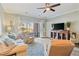 Comfortable living room features a ceiling fan, neutral walls, and wood flooring at 4803 Bovardia Pl. # 102, Myrtle Beach, SC 29577