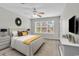 Beautiful bedroom features a decorative headboard, ceiling fan, and a large window providing natural light at 4940 Windsor Green Way # 203, Myrtle Beach, SC 29579